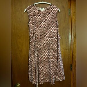 Jersey dress with crossover side tie belt and a flared skirt.